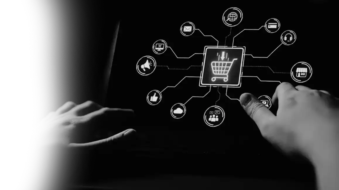 Marketer working on a laptop surrounded by digital channel icons